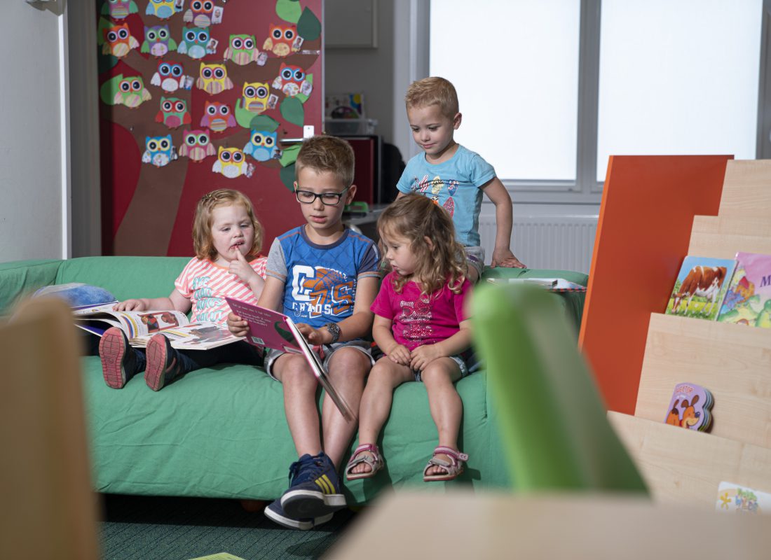 A little girl sitting on a table