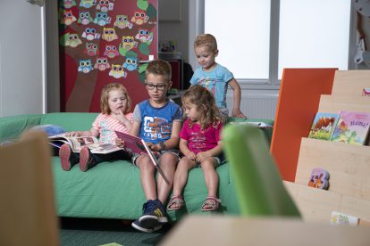 A little girl sitting on a table
